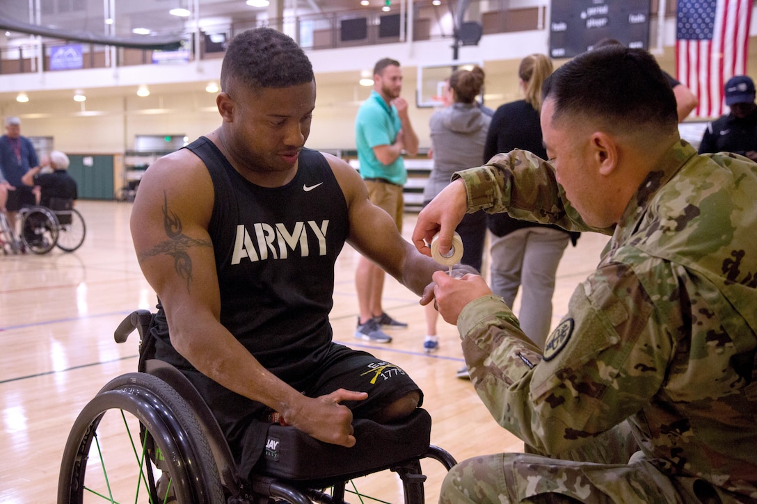 Army veteran Ryan Major gets assistance while training for the Warrior Care and Transition's Army Trials wheelchair basketball event at Fort Bliss, Texas, March 31, 2017. About 80 wounded, ill and injured active-duty soldiers and veterans are competing in eight different sports April 2-6 for the opportunity to represent Team Army at the 2017 Defense Department Warrior Games. Army photo by Pfc. Genesis Gomez