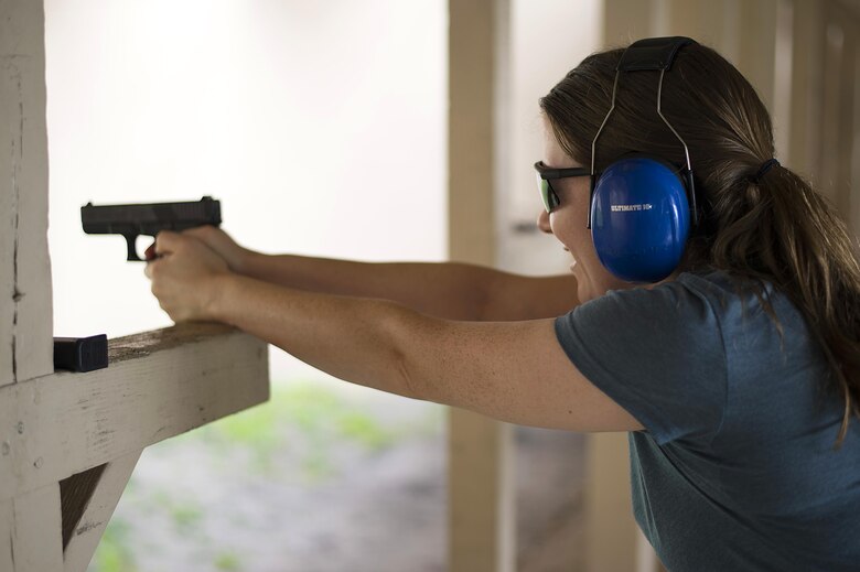 Christie Patterson, the wife of a Special Operations Command Central service member, fires a handgun as part of the Spartan Spouse Day held at MacDill Air Force Base, Fla., June 13, 2017. Spartan Spouse day allowed spouses to receive first-hand experience of what takes place within the special operations community. (U.S. Air Force photo by Airman 1st Class Caleb Nunez)
