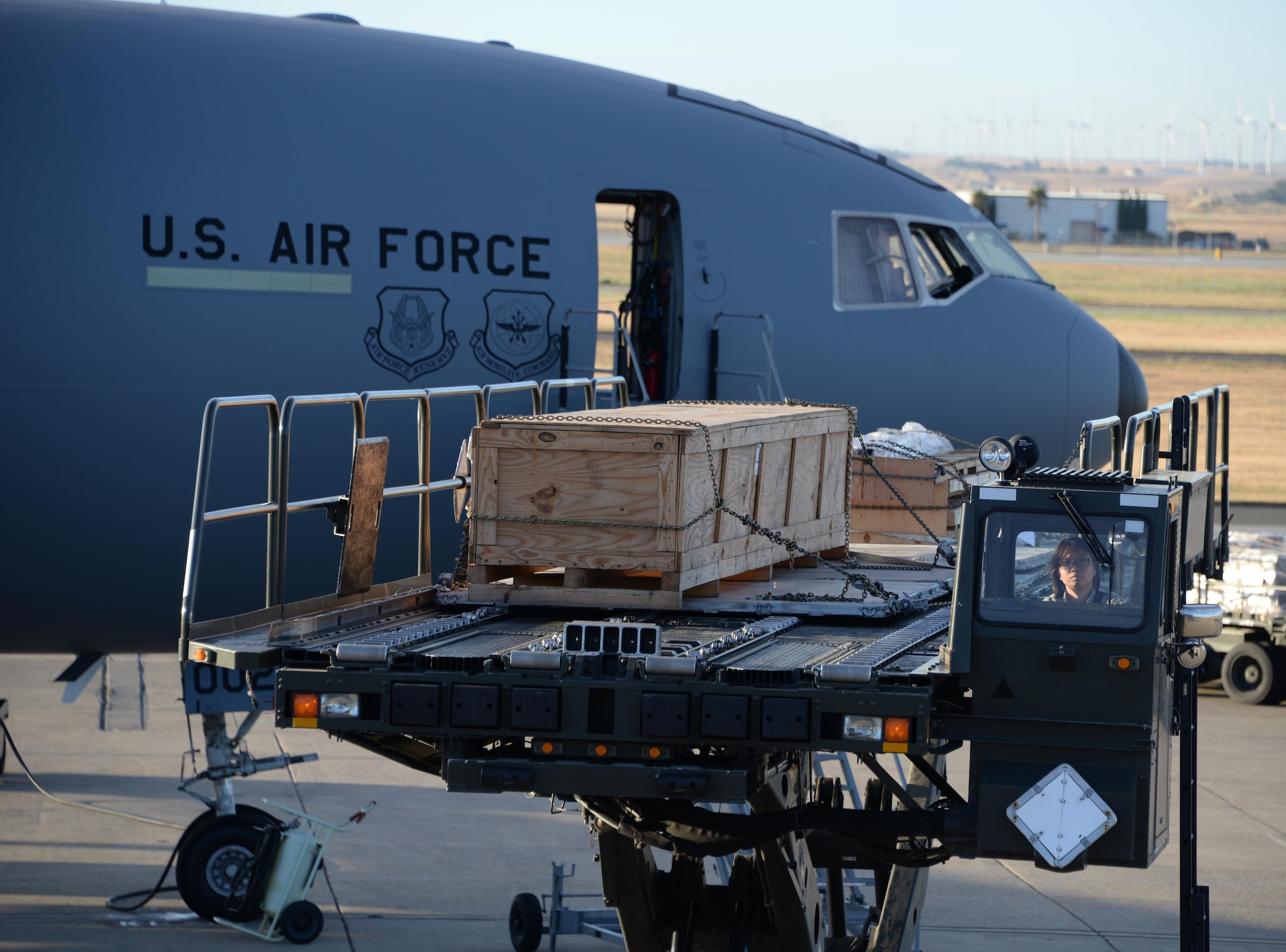 Airman 1st Class Jammie Lueck, 60th Aerial Port Squadron, positions a K-Loader prior to loading cargo onto a KC-10 Extender at Travis Air Force Base, Calif., June 17, 2017. Lueck helped load more than 15,000 pounds of cargo onto the aircraft prior to a flight to Joint Base Pearl Harbor-Hickam, Hawaii. The KC-10 is capable of transporting 170,000 pounds of cargo. (U.S. Air Force photo by Tech. Sgt. James Hodgman)