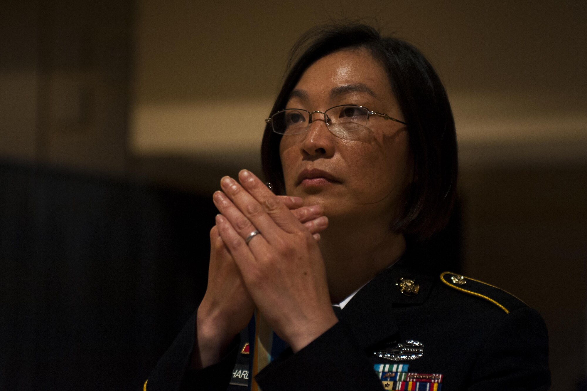 U.S. Army Staff Sgt. Akina Richardson, 344th Military Intelligence Battalion instructor, holds a ribbon during the Army Ball at the McNease Convention Center San Angelo, Texas, July 16, 2017. The streamers are symbols of accomplishments achieved by the unit such as fighting or support a particular battle. (U.S. Air Force photo by Senior Airman Scott Jackson)