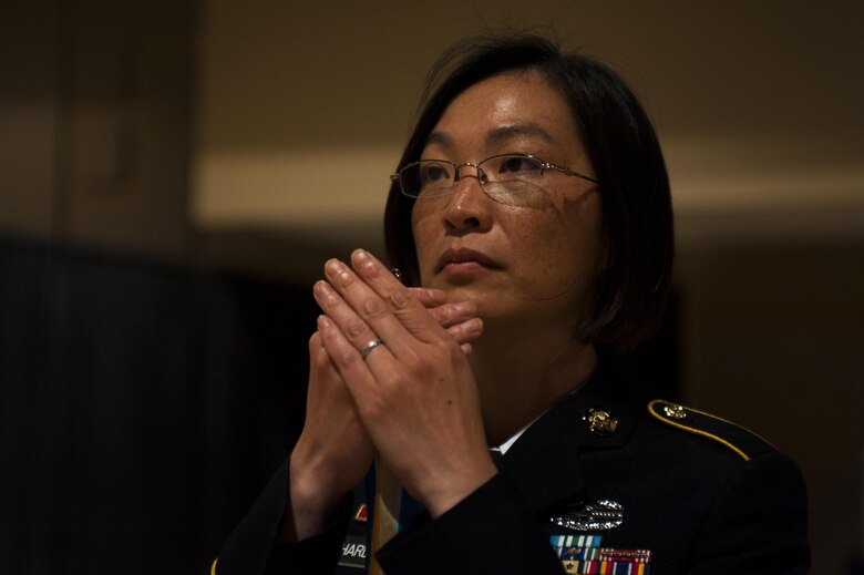 U.S. Army Staff Sgt. Akina Richardson, 344th Military Intelligence Battalion instructor, holds a ribbon during the Army Ball at the McNease Convention Center San Angelo, Texas, July 16, 2017. The streamers are symbols of accomplishments achieved by the unit such as fighting or support a particular battle. (U.S. Air Force photo by Senior Airman Scott Jackson)
