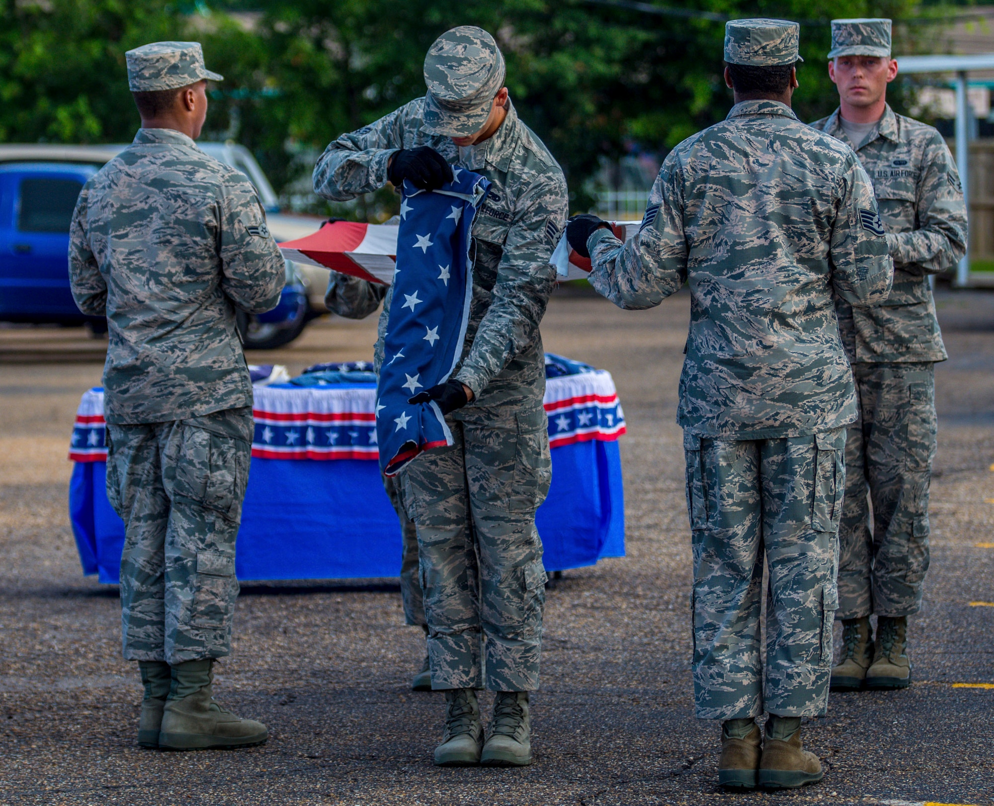 Senior Airman Anthony Padilla, 96th Aircraft Maintenance Squadron, folds the blue star section of the flag. Cutting the blue field of stars from the red and white stripes, thereby renders it no longer a flag. Honor Guards from Eglin Air Force Base and Hurlburt Field participated in the flag retirement ceremony held at the American Legion Post 235 in Fort Walton Beach, June 14. (U.S. Air Force photo/Kristin Stewart)