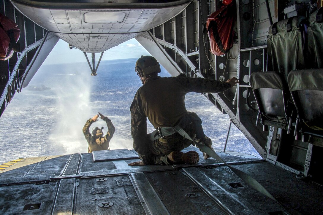 A Marine jumps from a CH-53E Super Stallion helicopter into the Philippine Sea during a helocast exercise, June 15, 2017. The Marine is embarked aboard the amphibious assault ship USS Bonhomme Richard, which is operating in the Indo-Asia-Pacific region. Navy photo by Seaman Apprentice Gavin Shields