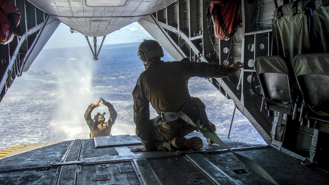 A Marine jumps from a CH-53E Super Stallion helicopter into the Philippine Sea during a helocast exercise, June 15, 2017. The Marine is embarked aboard the amphibious assault ship USS Bonhomme Richard, which is operating in the Indo-Asia-Pacific region. Navy photo by Seaman Apprentice Gavin Shields