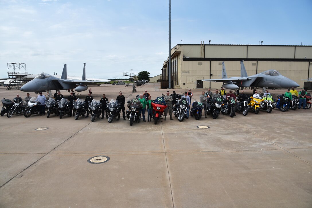 Chapter 54 of the Green Knights Military Motorcycle Club, Wichita Falls police officers and motorcyclists from Team Sheppard gather in front of two F-15 Strike Eagles, June 19, 2017. The GKMMC and the Sheppard safety office work together to educate new riders on base. (U.S. Air Force photo by 2nd Lt. Jacqueline Jastrzebski)