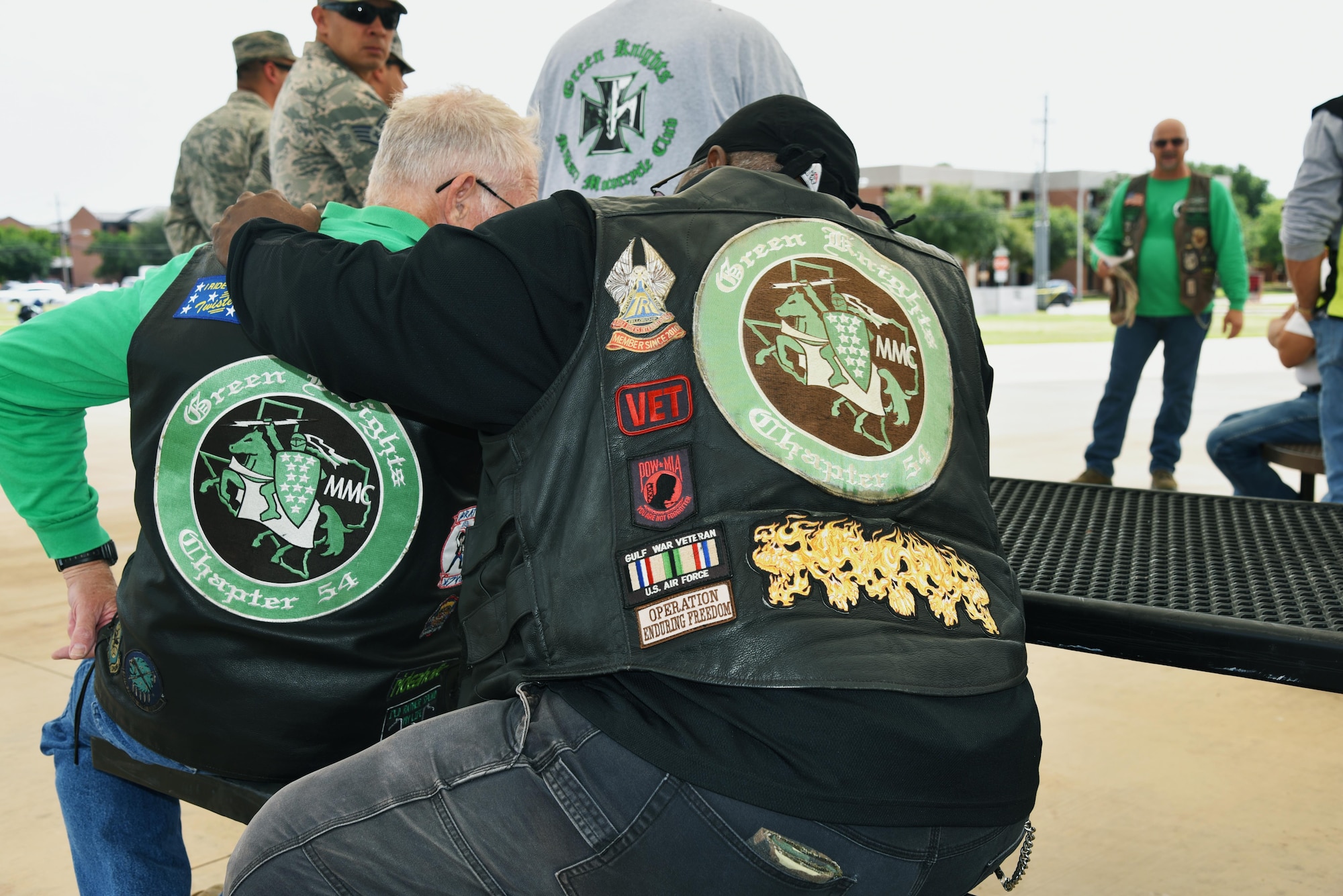 Members of the Green Knights Military Motorcycle Club listen to a safety brief before the Motorcycle Awareness Ride through base, June 19, 2017. GKMMC members proudly display patches and rank on their vests from their time in service. (U.S. Air Force photo by 2nd Lt. Jacqueline Jastrzebski)
