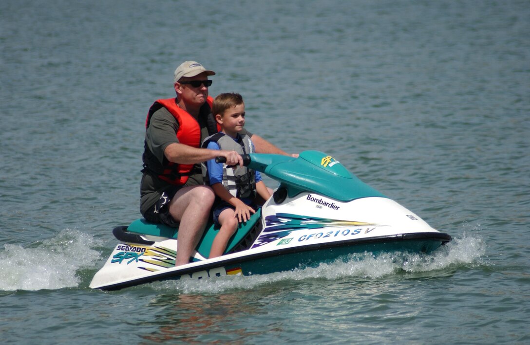 Ensuring they have proper-fitting lifejackets on, a father and son enjoy a ride on Black Butte Lake.