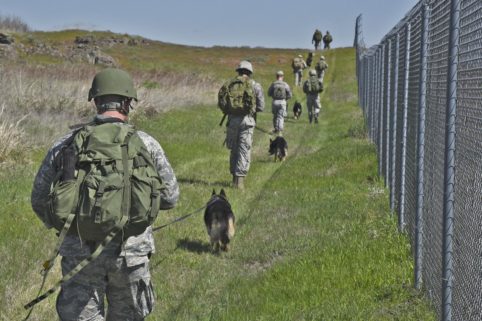 The 92nd Security Forces Squadron Military Working Dog section ruck marches to prepare for their upcoming deployments May 10, 2017, at Fairchild Air Force Base, Washington. MWD focuses on detection of explosives and narcotics and deterrence of individuals at home, in training and while deployed.  (U.S. Air Force photo/Senior Airman Mackenzie Richardson)