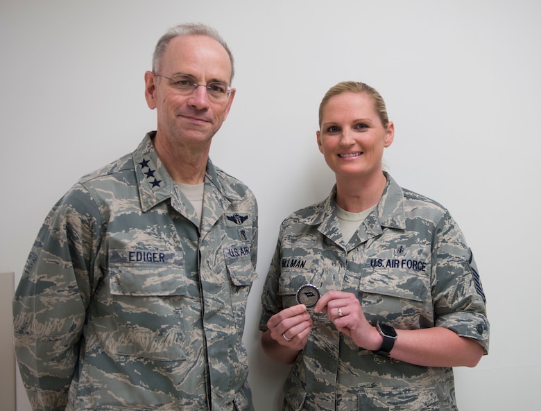 Master Sgt. Kori Hillman, 366th Medical Group urgent care clinic flight chief, stands with Lt. Gen. Mark Ediger, Air Force Surgeon General, after recieving a coin from him, June 14, 2017, at Mountain Home Air Force Base. Ediger coined high performers at the medical group during his visit. (U.S. Air Force photo by Senior Airman Malissa Lott/Released)