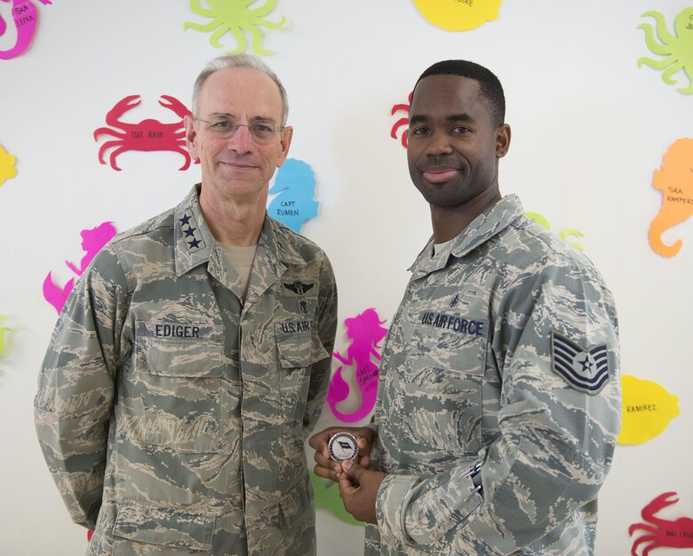 Tech. Sgt. Freddy Rengifo, 366th Medical Group women's health flight chief, stands with Lt. Gen. Mark Ediger, Air Force Surgeon General, after recieving a coin from him, June 14, 2017, at Mountain Home Air Force Base. Ediger coined high performers at the medical group during his visit. (U.S. Air Force photo by Senior Airman Malissa Lott/Released)