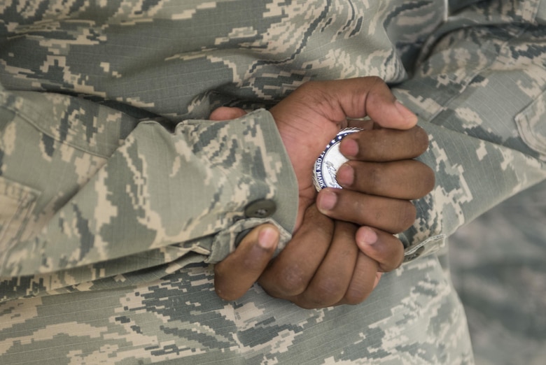 Tech. Sgt. Freddy Rengifo, 366th Medical Group women's health flight chief, holds the coin he recieved from Lt. Gen. Mark Ediger, Air Force Surgeon General, June 14, 2017, at Mountain Home Air Force Base. Ediger coined high performers at the medical group during his visit. (U.S. Air Force photo by Senior Airman Malissa Lott/Released)