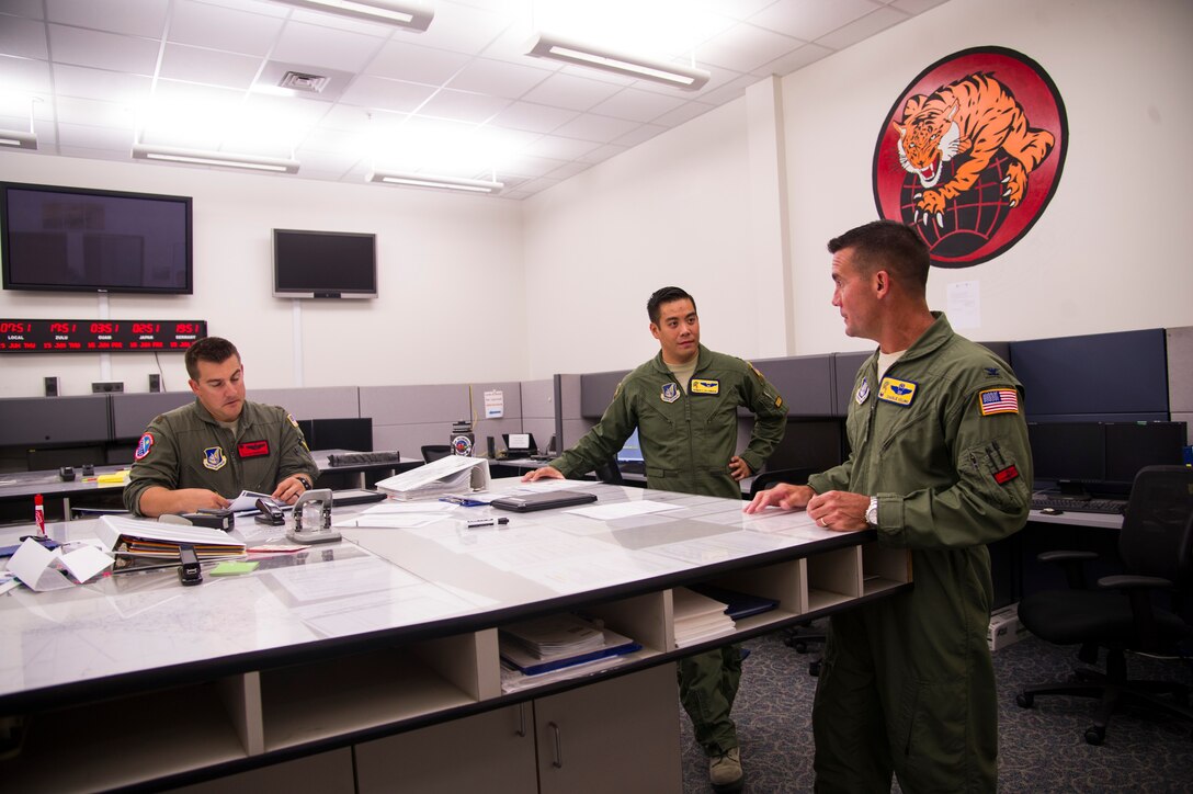 Col. Charles Velino, 15th Operations Group commander, gives a mission briefing to Maj. Justin Carmona, 535th Operations Support Squadron pilot, and Capt. Reinier Villanueva, 15th Operations Support Squadron C-17 flight instructor pilot, for Velino’s final flight at Joint Base Pearl Harbor-Hickam, Hawaii, June 16, 2017.  Velino is a command pilot with over 3,500 flying hours and will be leaving the 15th Operations Group to take command of the 47th Flying Training Wing in Laughlin AFB, Texas. (U.S. Air Force photo by Tech Sgt. Heather Redman)