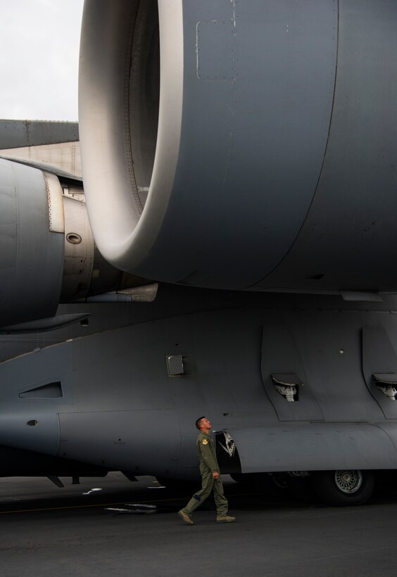 Col. Charles Velino, 15th Operations Group commander, does a pre-flight inspection of a C-17 Globemaster III before his final flight at Joint Base Pearl Harbor-Hickam, Hawaii, June 16, 2017.  Velino is a command pilot with over 3,500 flying hours and will be leaving the 15th Operations Group to take command of the 47th Flying Training Wing in Laughlin AFB, Texas. (U.S. Air Force photo by Tech Sgt. Heather Redman)