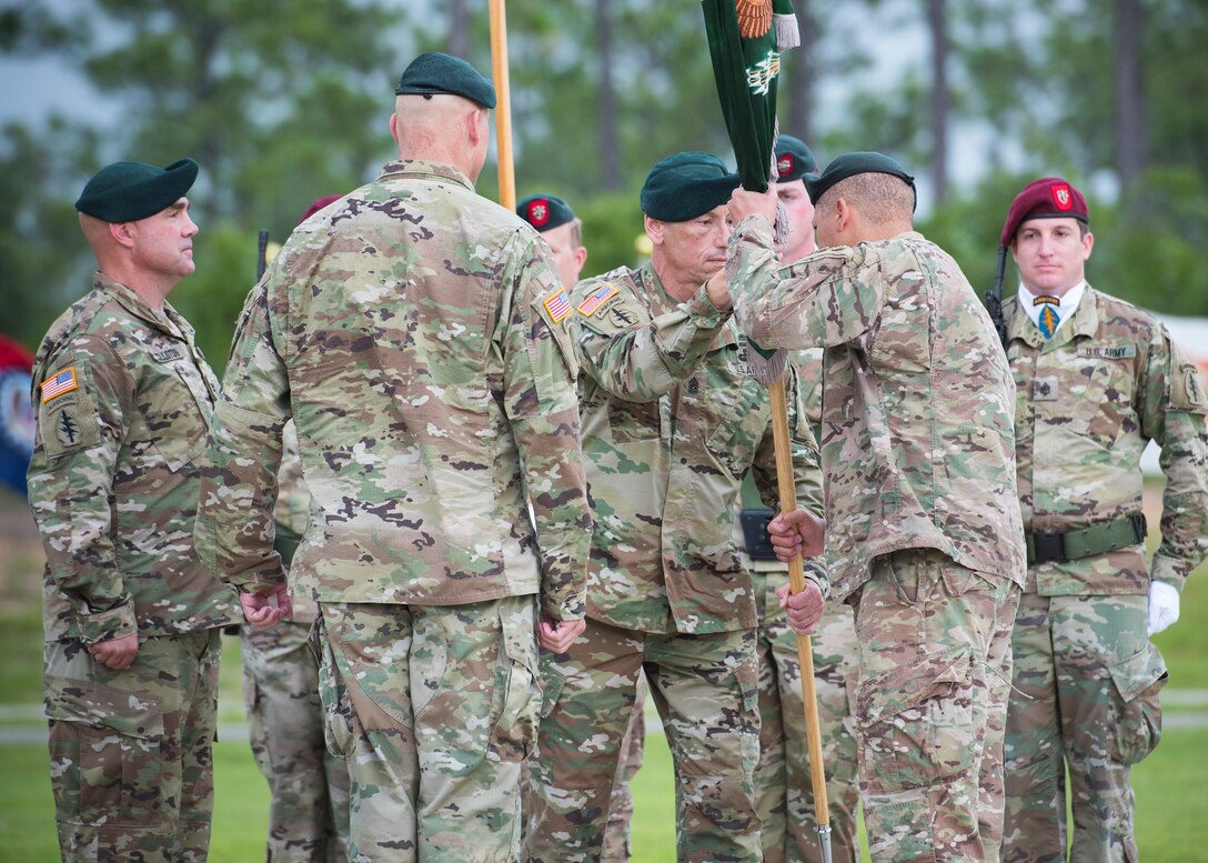 U.S. Army Command Sgt. Major Mark Thibeau, 7th Special Forces Group (Airborne), passes the Group colors to Col. Michael Ball, the outgoing commander, during a change of command ceremony June 15 at Eglin Air Force Base, Fla. During the ceremony Col. Michael Ball relinquished command of the 7th SFG(A) to Col. Patrick Colloton. The passing of the Group’s colors marks the change of command. (U.S. Air Force photo/Ilka Cole)