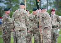 U.S. Army Command Sgt. Major Mark Thibeau, 7th Special Forces Group (Airborne), passes the Group colors to Col. Michael Ball, the outgoing commander, during a change of command ceremony June 15 at Eglin Air Force Base, Fla. During the ceremony Col. Michael Ball relinquished command of the 7th SFG(A) to Col. Patrick Colloton. The passing of the Group’s colors marks the change of command. (U.S. Air Force photo/Ilka Cole)