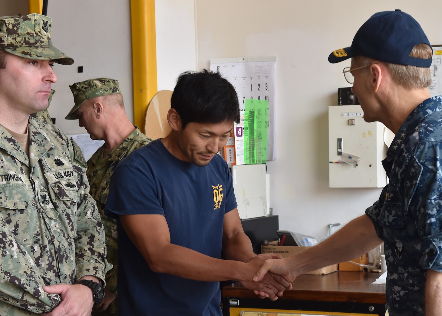 YOKOSUKA, Japan (June 19, 2017) Vice Adm. Joseph Aucoin, commander of U.S. 7th Fleet, thanks Masaki Kanno, a Japanese professional diver, for his work on the guided-missile destroyer USS Fitzgerald (DDG 62) afer its collision with a merchant vessel, June 17, 2017. Fitzgerald suffered severe damage, but returned to Fleet Activities Yokosuka under its own power. The incident is under investigation. (U.S. Navy photo by Mass Communication Specialist 2nd Class Richard L.J. Gourley/Released)