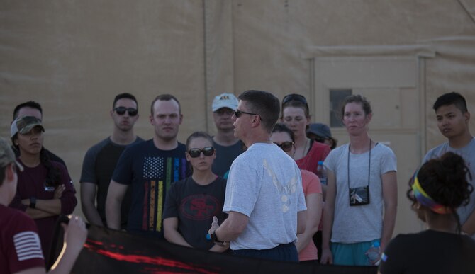 Brig. Gen. Kyle W. Robinson, 332nd Air Expeditionary Wing commander, gives opening remarks prior to a memorial walk June 12, 2017, in Southwest Asia. The walk commemorated those who lost their lives during the massacre at the Orlando Pulse nightclub. (U.S. Air Force photo/Senior Airman Damon Kasberg)