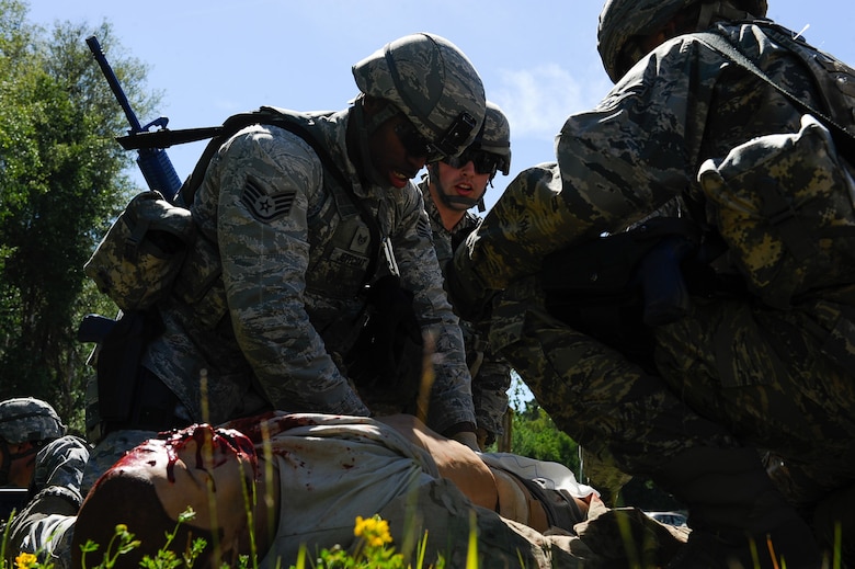 Staff Sgt. Eric Jeffcoat, 100th Security Forces Squadron base defense operation center controller, applies pressure to a simulated wound during the 435th SFS’s Ground Combat Readiness Training Center Security Operations Course on Ramstein Air Base, Germany, June 12, 2017. As part of their training, students received Tactical Combat Casualty Care (TCCC) training from Ramstein medical personnel. (U.S. Air Force photo by Airman 1st Class Savannah L. Waters)