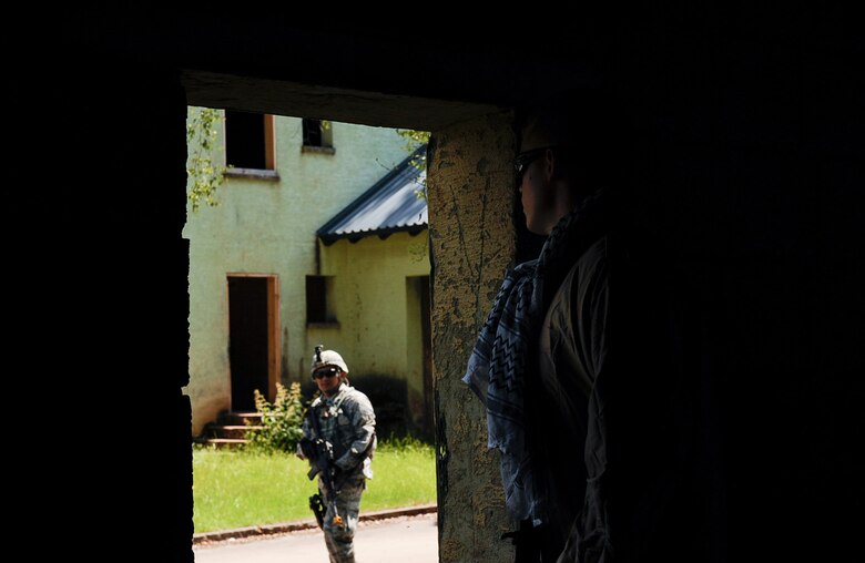 A 435th Security Forces Squadron’s Ground Combat Readiness Training Center Security Operations Course volunteer hides from a SOC student at U.S. Army Garrison Baumholder, Germany, June 15, 2017. During the urban operations, volunteers enacted opposition forces (OPFOR) operations to enhance training scenarios for the trainees. (U.S. Air Force photo by Airman 1st Class Savannah L. Waters)