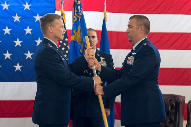 Lt. Col. Judd Baker (left) accepts the 43d Operations Support Squadron guidon from Col. Kelly Holbert, 43d Air Mobility Operations Group commander, during a ceremony here June 9. Baker took command of the 43d OSS from Lt. Col. Christopher Kiser, who left Pope for an assignment at Scott Air Force Base, Ill. (U.S. Air Force photo/Marc Barnes)
