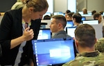 Austin Whisnant, a cyber exercise developer for the Cyber Workforce Development Team at Carnegie Mellon University, assists a Solider on day one of the Cyber X-Games, hosted by the Army Reserve Cyber Operations Group (ARCOG), 335th Signal Command (Theater), June 15, 2017, at Carnegie-Mellon University in Pittsburgh. Cyber X-Games is a five-day exercise focusing on advanced areas of cyber security training. 