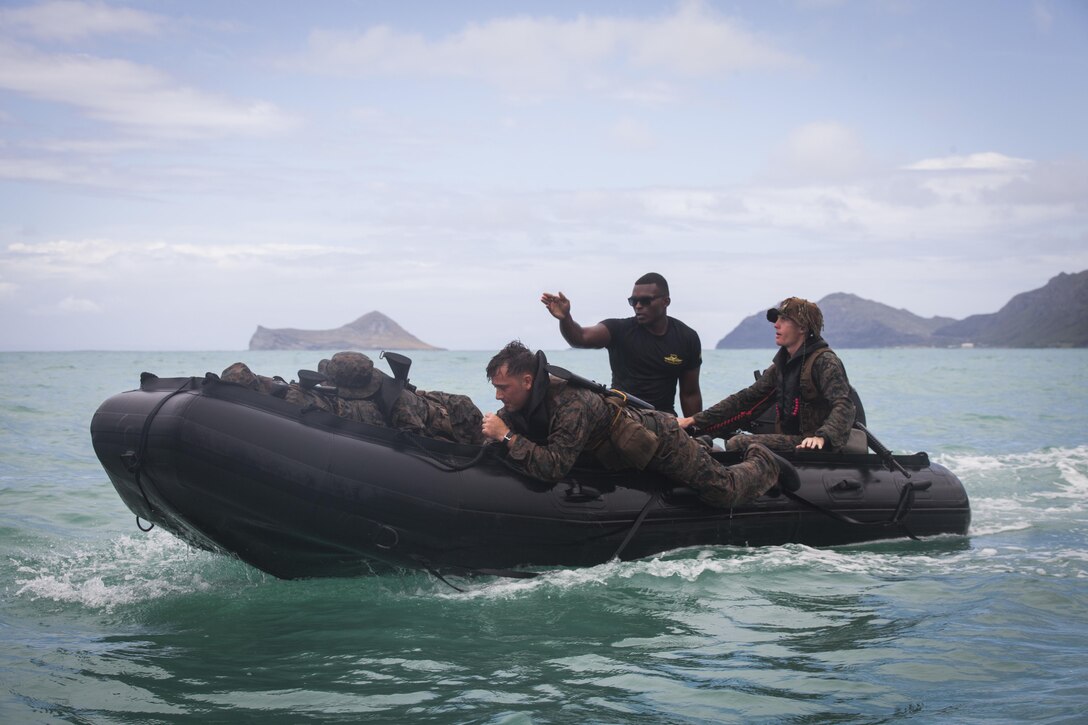 Sgt. Antuan D. Martin, lead instructor of Raider Reconnaissance Operator Course, instructs Marines on amphibious operations during an exercise aboard Marine Corps Training Area Bellows, June 15, 2017. Martin demonstrated how to safely launch and beach their Zodiac inflatable craft with several surf passage exercises. 