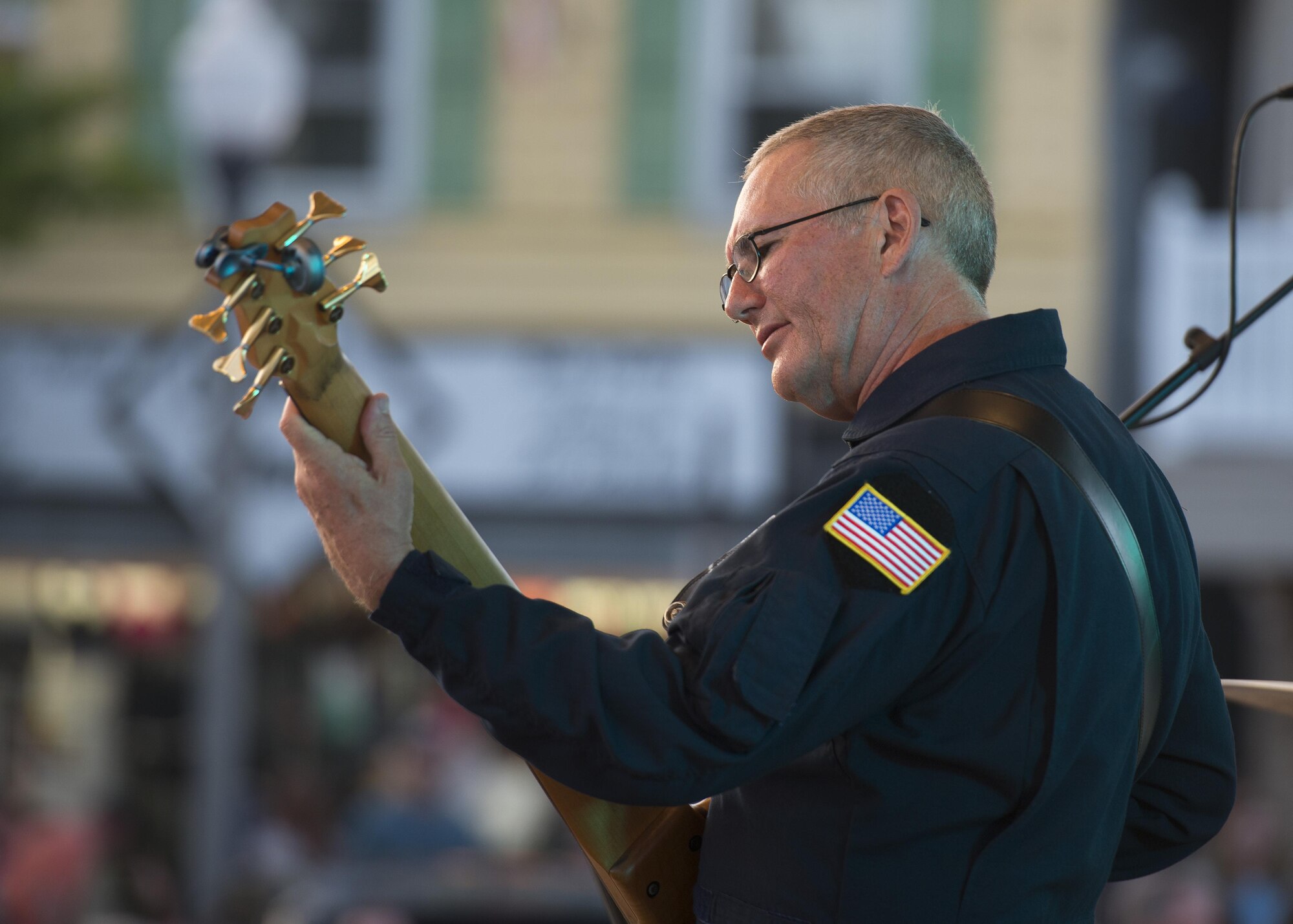Master Sgt. David Foster, Max Impact electric bass player, plays the bass June 17, 2017, at the Rehoboth Beach Bandstand, in Rehoboth Beach, Del. Max Impact honors those who have served, inspires American citizens to heightened patriotism and service, and positively impacts the global community on behalf of the U.S. Air Force and the U.S. (U.S. Air Force photo by Senior Airman Zachary Cacicia)