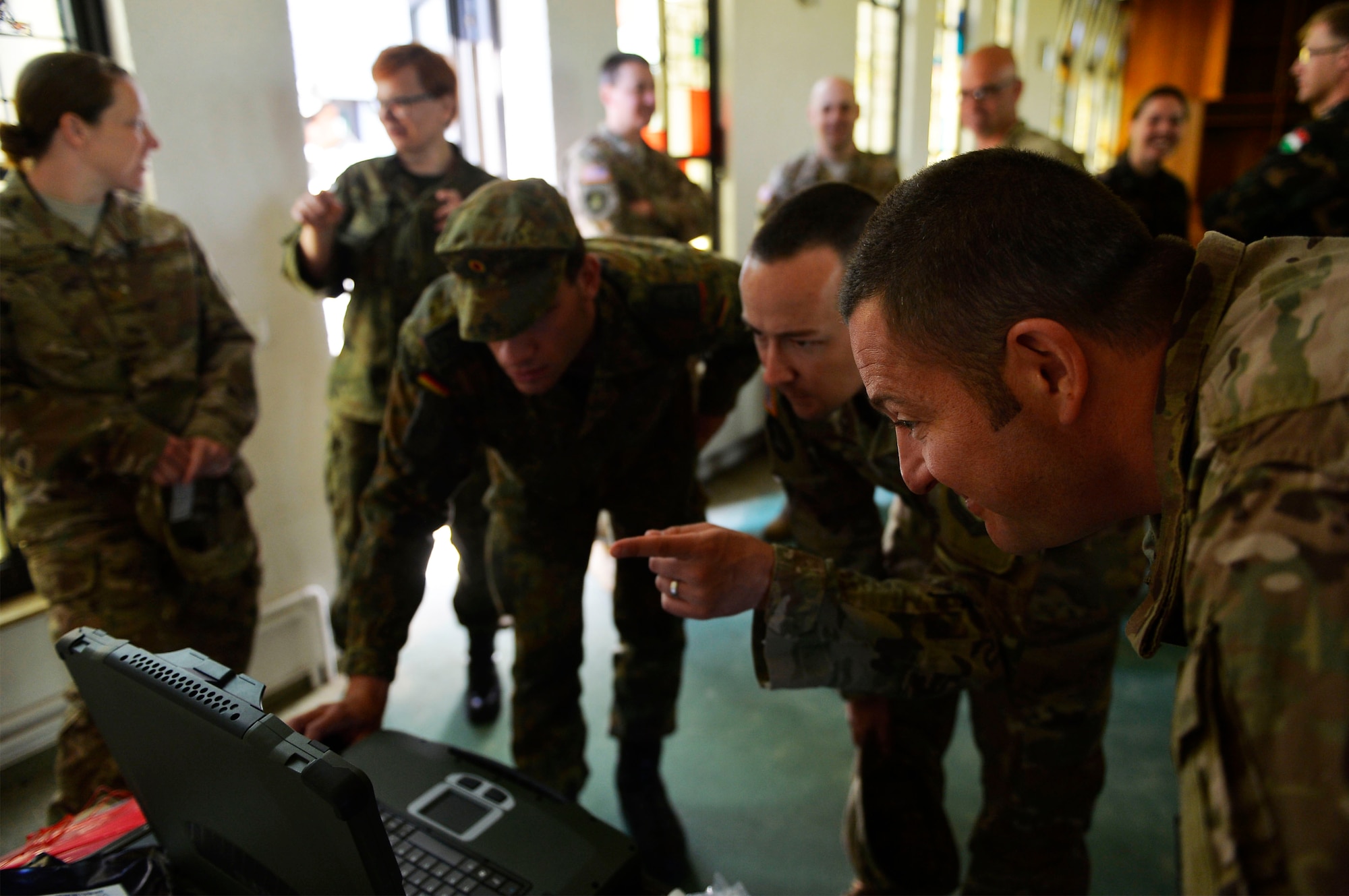 U.S. Air Force and German service members examine weather data on a computer at McCully Barracks, Germany, June 15, 2017. Ramstein’s 7th Weather Squadron Airmen, along with allies from Germany, Poland, and Hungary, conducted Exercise Cadre Focus 17-1, where they aimed to enhance interoperability for joint missions. Cadre Focus is a biannual training program used by the 7th WS to certify its Airmen in common Soldier tasks to cooperate with the U.S. Army. (U.S. Air Force photo by Airman 1st Class Joshua Magbanua)
