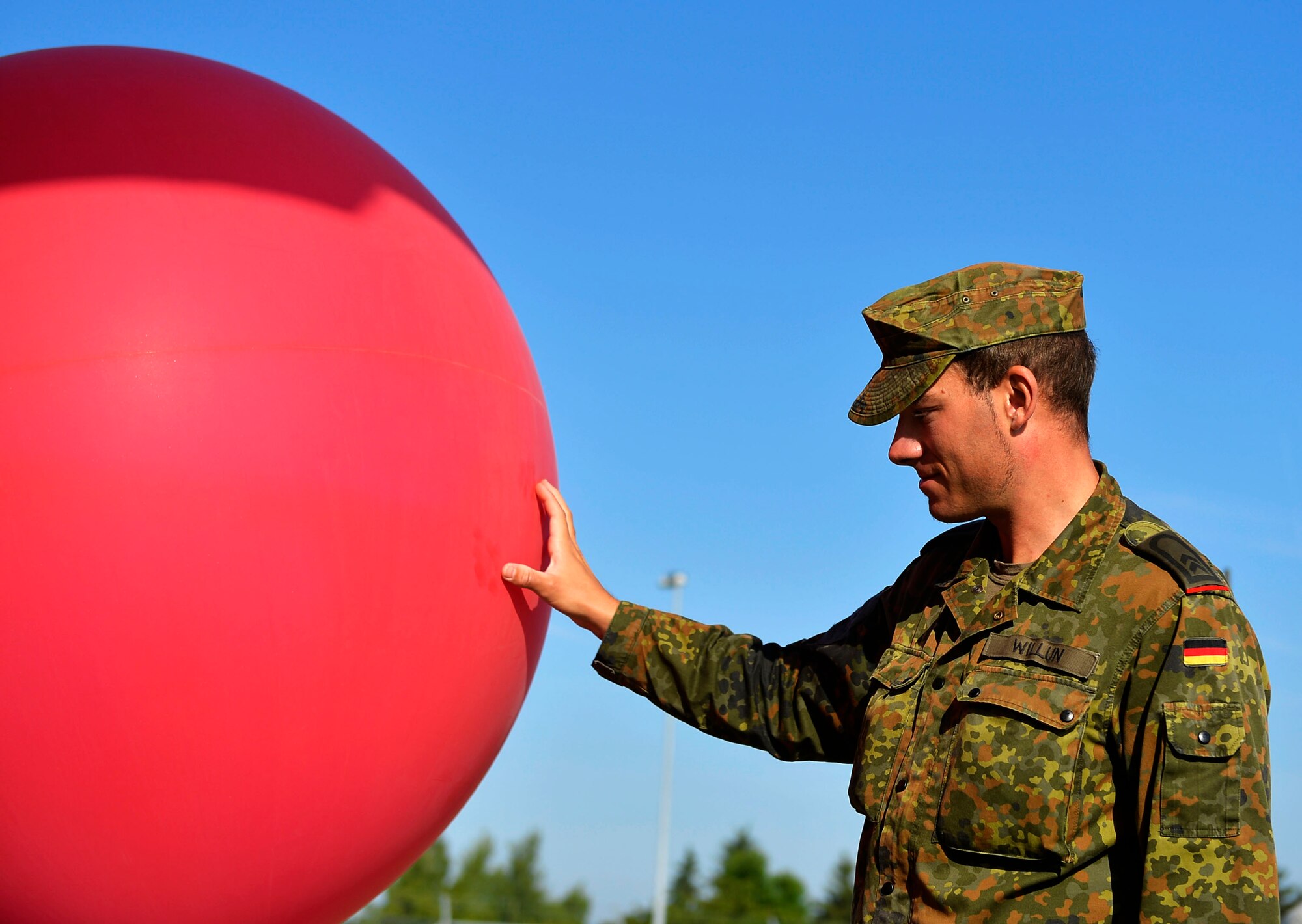 German Army Sergeant Joern Willun, a weather observer, prepares a weather balloon for launch at McCully Barracks, Germany, June 15, 2017. Ramstein’s 7th Weather Squadron invited NATO allies from Germany, Poland, and Hungary to participate in Exercise Cadre Focus 17-1, which the squadron uses to enhance cooperation while testing its capabilities. (U.S. Air Force photo by Airman 1st Class Joshua Magbanua)