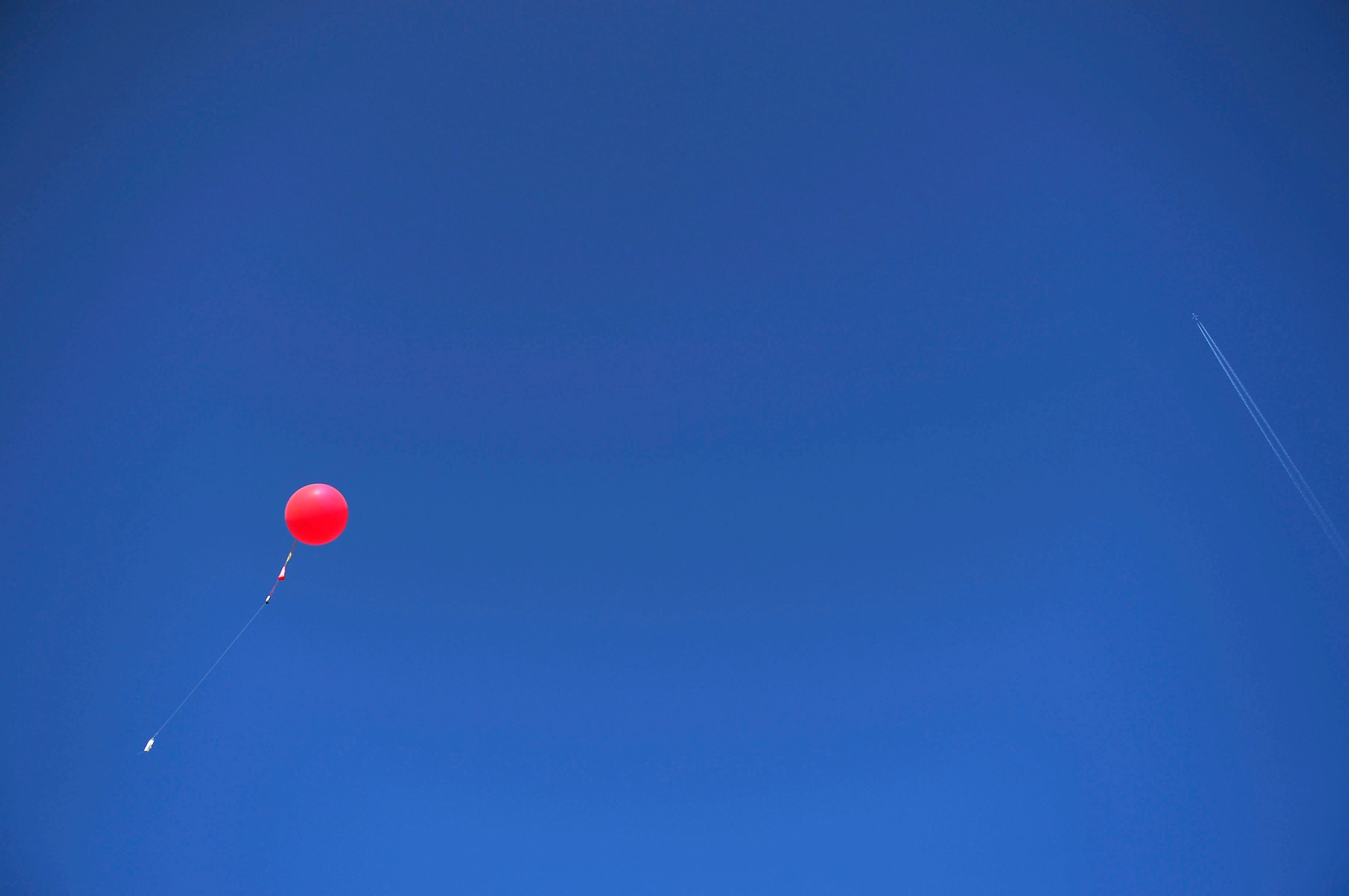 A weather balloon floats into the sky over McCully Barracks, Germany, June 15, 2017. Weather balloons are used to carry instruments into the atmosphere to collect weather data. The 7th Weather Squadron conducted Exercise Cadre Focus 17-1 with NATO allies from Germany, Poland, and Hungary. (U.S. Air Force photo by Airman 1st Class Joshua Magbanua)