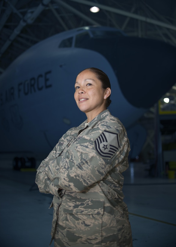 Master Sgt. Josette Wheeler, Knowledge Operations Specialist, 914th Maintenance Squadron, stands in front of a KC-135 Stratotanker in an aircraft hangar. MSgt. Wheeler is a proud member of the 914th, the American Legion and the Six Nations. (U.S. Air Force photo by Tech. Sgt. Stephanie Sawyer) 