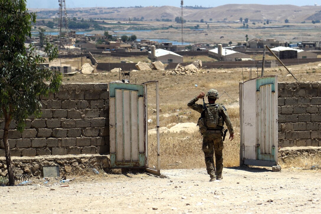 A U.S. soldier deployed in support of Combined Joint Task Force Operation Inherent Resolve leaves a tactical assembly area during an operation to advise and assist Iraqi partners, near Mosul, Iraq, June 7, 2017. The 2nd Brigade Combat Team, 82nd Airborne Division, enables their Iraqi partners through the advise and assist mission, contributing planning, intelligence collection and analysis, force protection and precision fires to achieve the military defeat of ISIS. Army photo by Staff Sgt. Jason Hull