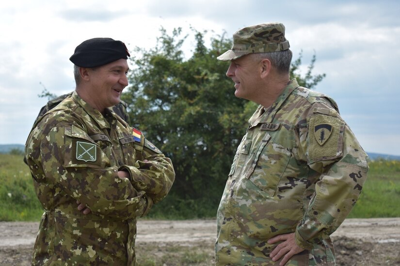 Brig. Gen. Gheorghita Vlad, Commander of Joint National Training Center, and Brig. Gen. Phillip Jolly, United States Army Europe, Deputy Commanding General for Mobilization and Reserve Affairs, United States Army Europe, discuss the construction projects at JNTC, Cincu, Romania. U.S., U.K., and Romanian engineers are building a non-standard live-fire range, breaching and demolitions range. Resolute Castle 2017 is an exercise strengthening the NATO alliance and enhancing its capacity for joint training and response to threats within the region.