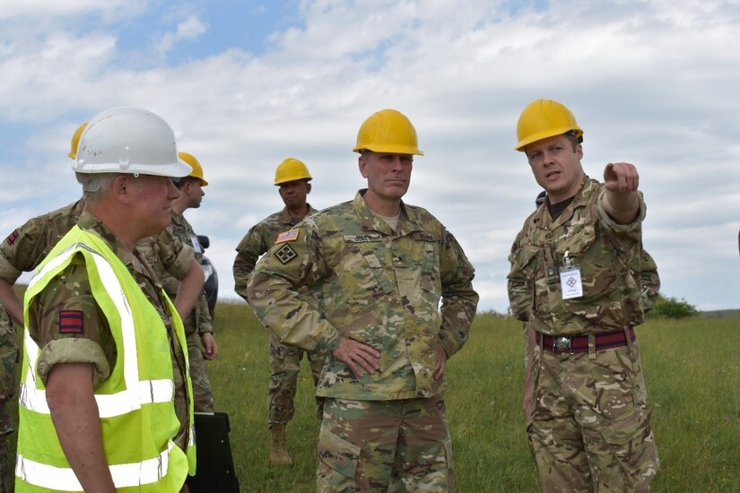 Maj. Gareth Stockman, U.K. Royal Monmouthshire Royal Engineers-Militia, shows Brig. Gen. Phillip S. Jolly the U.K. project site at Joint National Training Center, Cincu, Romania. The Royal Engineers are in charge of building infrastructure for a sniper range as part of Operation Resolute Castle 2017. Resolute Castle is an exercise strengthening the NATO alliance and enhancing its capacity for joint training and response to threats within the region.