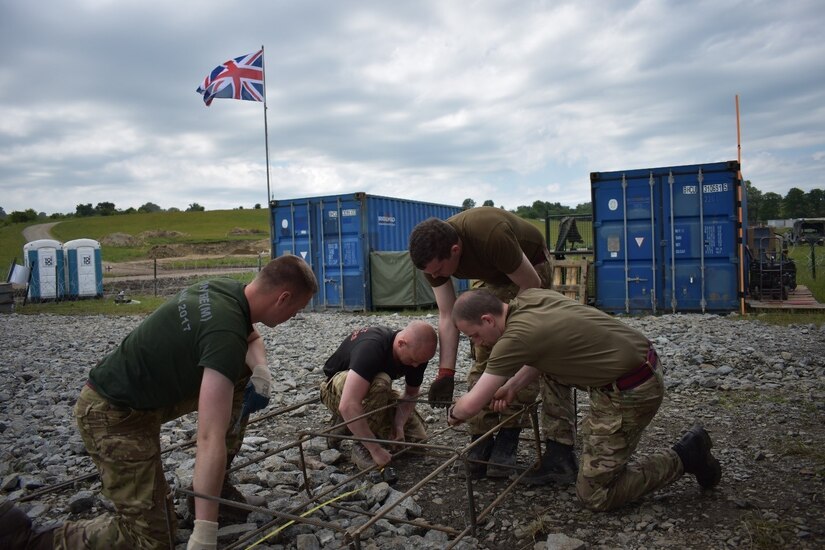 Soldiers of the United Kingdom Royal Monmouthshire Royal Engineers tie re-bar for sniper range infrastructure as a part of Operation Resolute Castle 2017 at the Joint National Training Center, Cincu, Romania. Resolute Castle is an exercise strengthening the NATO alliance and enhancing its capacity for joint training and response to threats within the region.