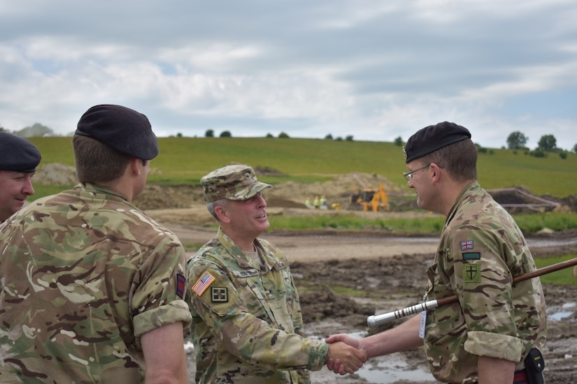 Company Sergeant Major John Ohara, U.K. Royal Monmouthshire Royal Engineers-Militia, welcomes Brig. Gen. Phillip S. Jolly to his worksite at the Joint National Training Center, Cincu, Romania. The Royal Engineers are in charge of building infrastructure for a sniper range as part of Operation Resolute Castle 2017.  Resolute Castle is an exercise strengthening the NATO alliance and enhancing its capacity for joint training and response to threats within the region.