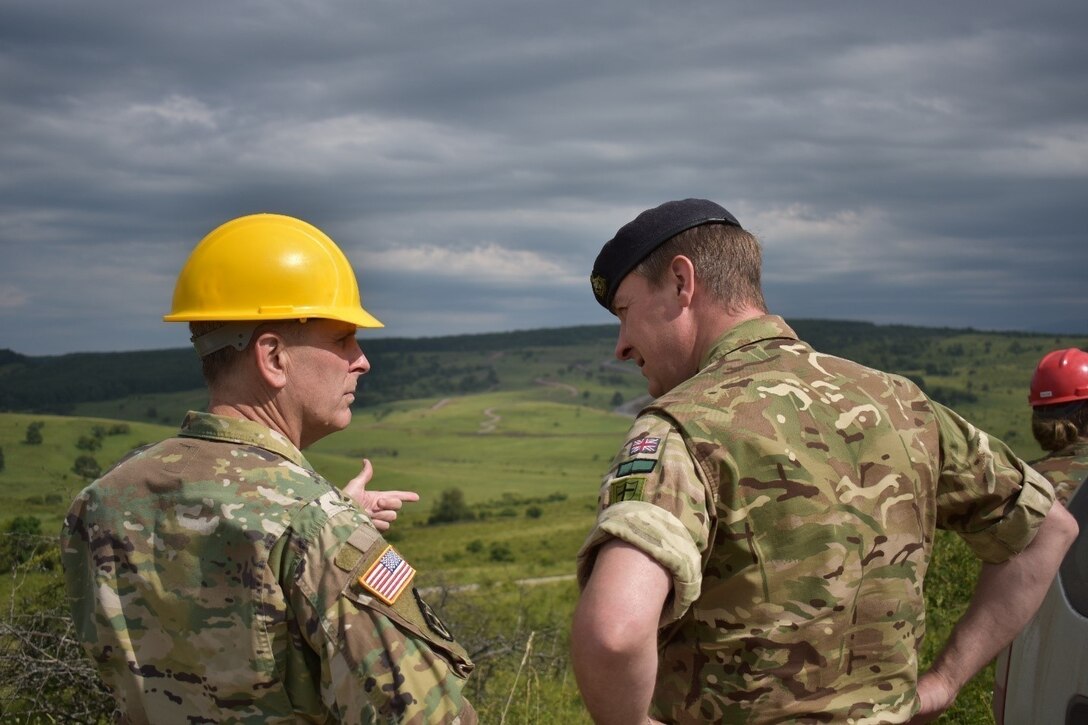 Brig. Gen. Phillip Jolly, Deputy Commanding General for Mobilization and Reserve Affairs, United States Army Europe, and Lt. Col. Scott Spencer, Commander of UK Royal Monmouthshire Royal Engineers (Militia), discuss the progress on the Non-Standard Live-Fire Range at Joint National Training Center. U.S. Reserve and National Guard Soldiers are working with British Royal Engineers, Navy Seabees, and Romanian Engineers as a part of Operation Resolute Castle 2017. Resolute Castle is an exercise strengthening the NATO alliance and enhancing its capacity for joint training and response to threats within the region.