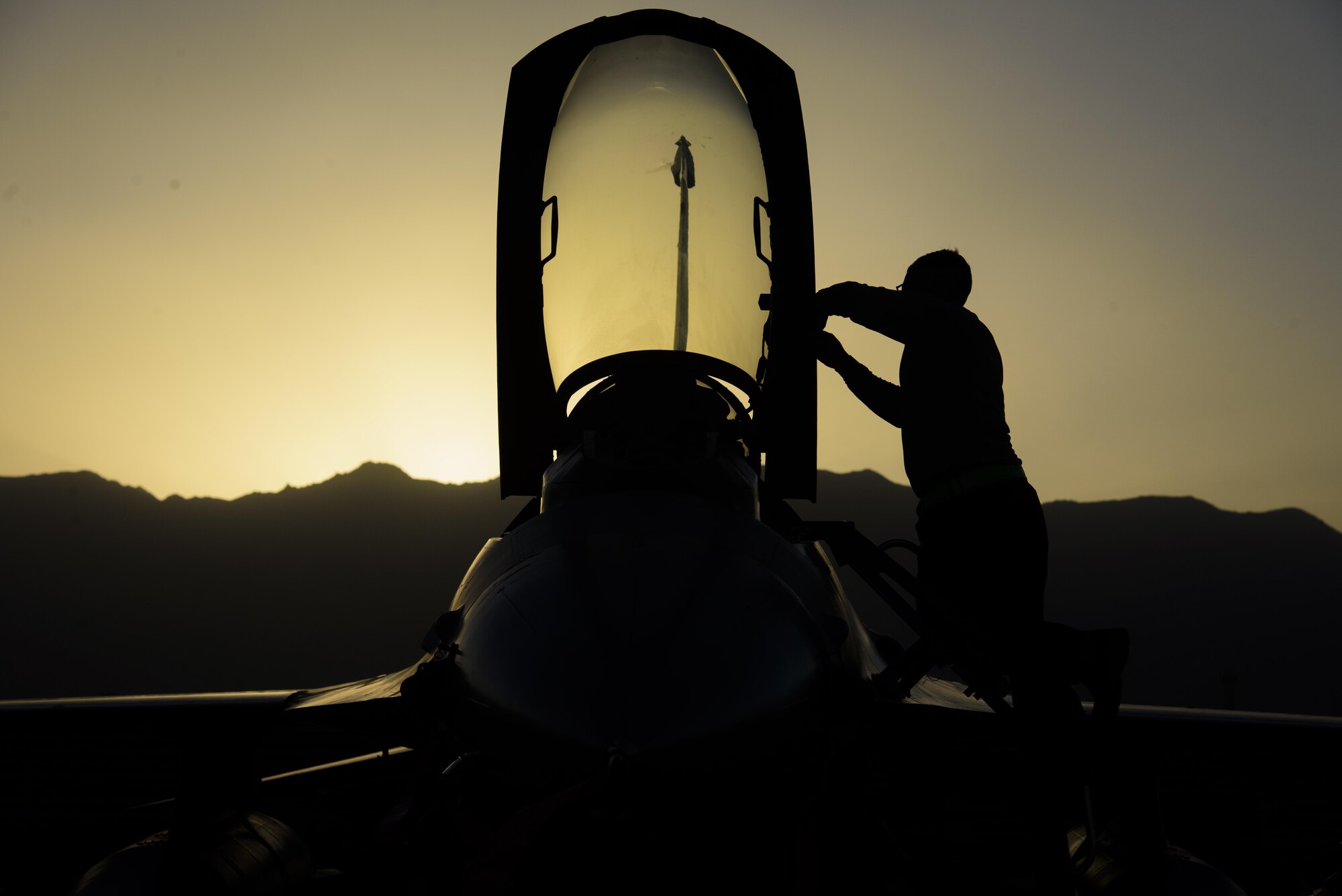 Senior Airman Alexis Garrido, a 455th Expeditionary Aircraft Maintenance Squadron dedicated crew chief, removes paint from an F-16 Fighting Falcon on Bagram Airfield, Afghanistan, June 16, 2017. Maintainers work day and night during extreme heat and freezing weather ensuring “Ops never stops.” (U.S. Air Force photo by Staff Sgt. Benjamin Gonsier) 