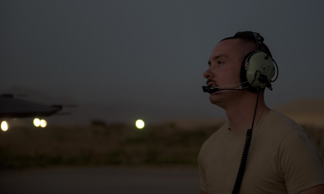 Senior Airman Kyle Bieri, a 455th Expeditionary Aircraft Maintenance Squadron aerospace propulsion technician, communicates with a team member during an F-16 Fighting Falcon afterburner run at Bagram Airfield, Afghanistan, June 16, 2017. Bieri is deployed out of Aviano Air Base, Italy, and supports the F-16 Fighting Falcons assigned to the 555th Expeditionary Fighter Squadron. (U.S. Air Force photo by Staff Sgt. Benjamin Gonsier) 