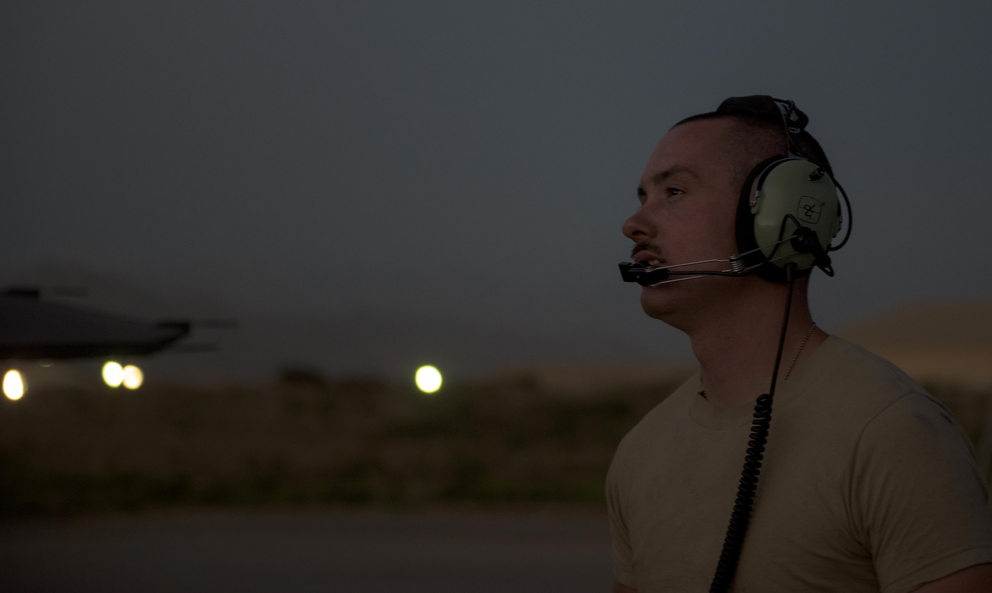 Senior Airman Kyle Bieri, a 455th Expeditionary Aircraft Maintenance Squadron aerospace propulsion technician, communicates with a team member during an F-16 Fighting Falcon afterburner run at Bagram Airfield, Afghanistan, June 16, 2017. Bieri is deployed out of Aviano Air Base, Italy, and supports the F-16 Fighting Falcons assigned to the 555th Expeditionary Fighter Squadron. (U.S. Air Force photo by Staff Sgt. Benjamin Gonsier) 