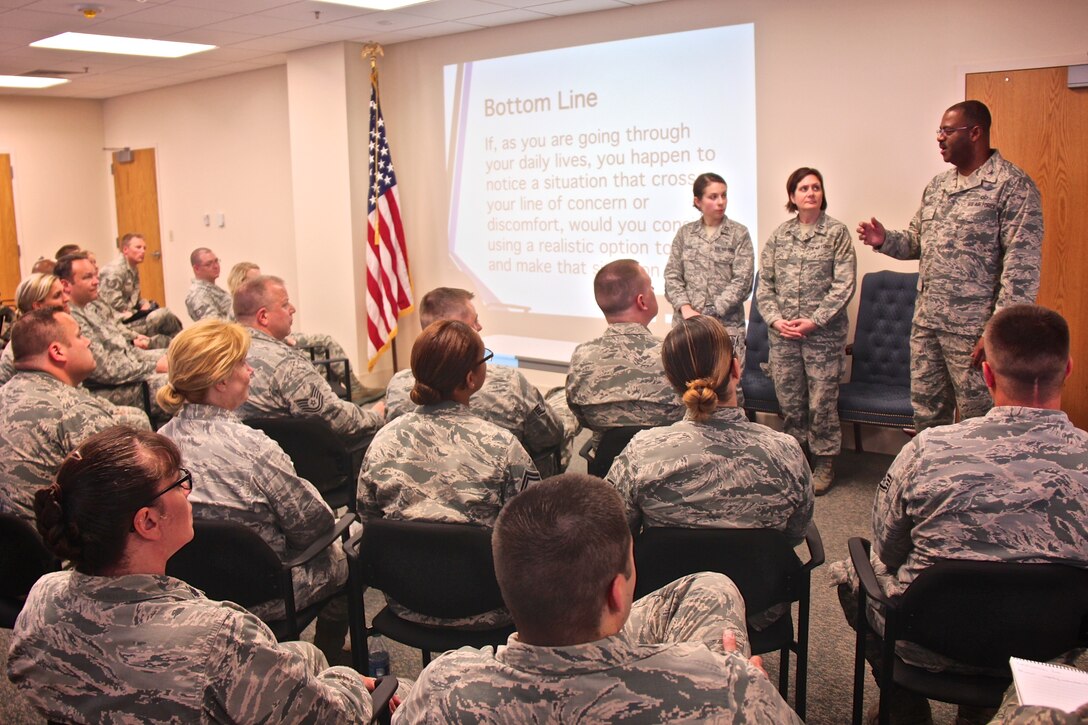 At far right, the 932nd Airlift Wing commander, Col. Esteban Ramirez, speaks to a full class of Airmen at the Green Dot Training Course held in the base clinic.  Green Dot is a program that prepares organizations to implement a strategy of violence prevention that reduces power-based interpersonal violence, which includes not only sexual violence, but also domestic violence, dating violence, stalking, child abuse, elder abuse, and bullying.  The 932nd Airlift Wing course was taught by Capt. Eva Leven and Capt. Rachael Dompke, (standing from left to right), on June 11, 2017, Scott Air Force Base, Illinois.  They interacted with the audience regarding ways to intervene in challenging situations with realistic options. They informed the 932nd AW Airmen of the four steps a bystander can take when an issue arises – recognizing the warning signs; understanding the barriers to intervening; intervening by directing, delegating or distracting; and strengthening the protective factors associated with sexual assault.  (U.S. Air Force photo by Lt. Col. Stan Paregien)