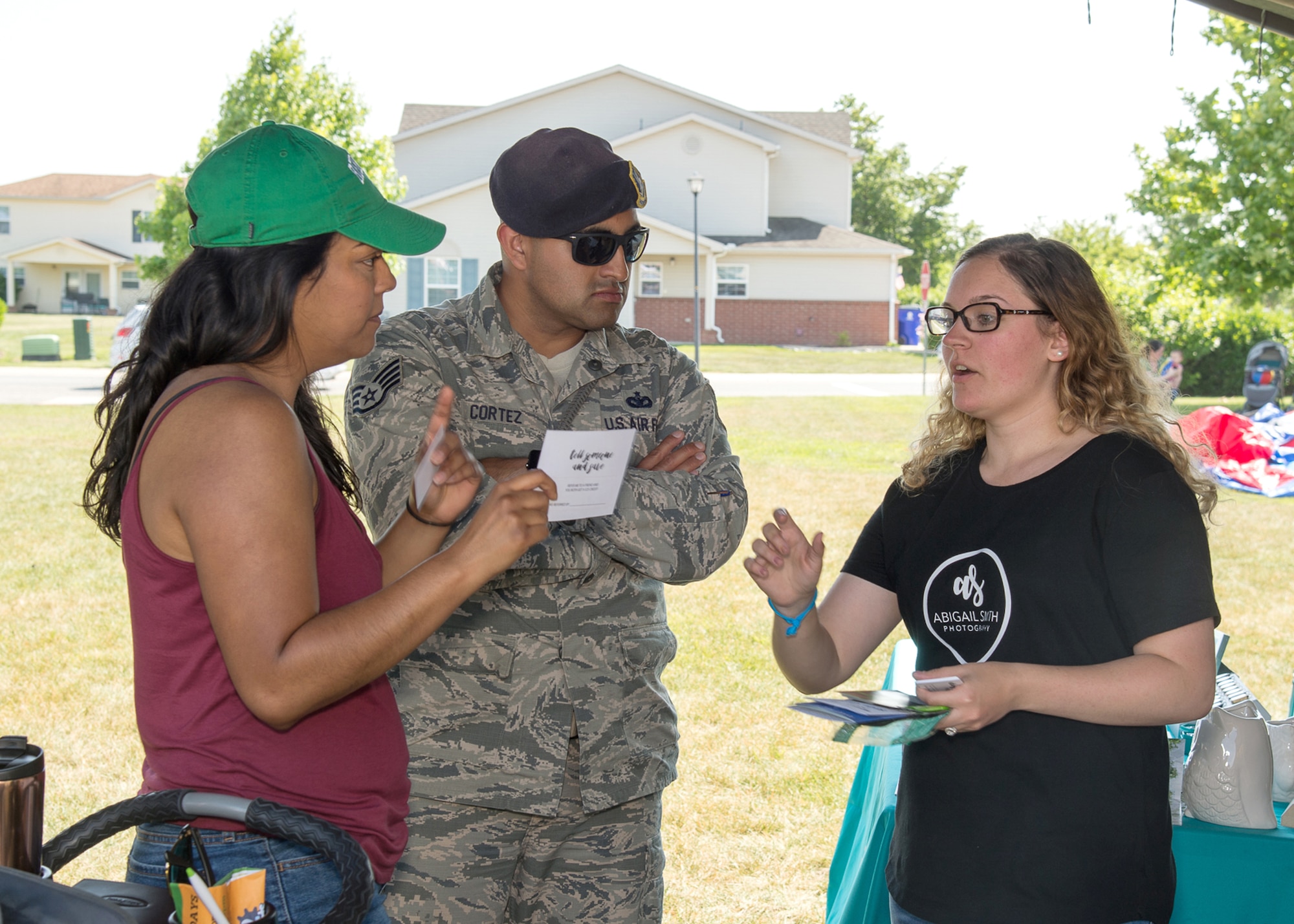 Staff Sgt. Carlos Cortez, 436th Security Forces Squadron military working dog trainer, and his wife Deanna speak with Abigail Smith, owner of Abigail Smith Photography, during the Hurricane Block Party June 15, 2017, in the Eagle Heights family housing on Dover Air Force Base, Del. Besides providing helpful emergency information, attendees could also tour several booths set up by local vendors. (U.S. Air Force photo by Mauricio Campino)