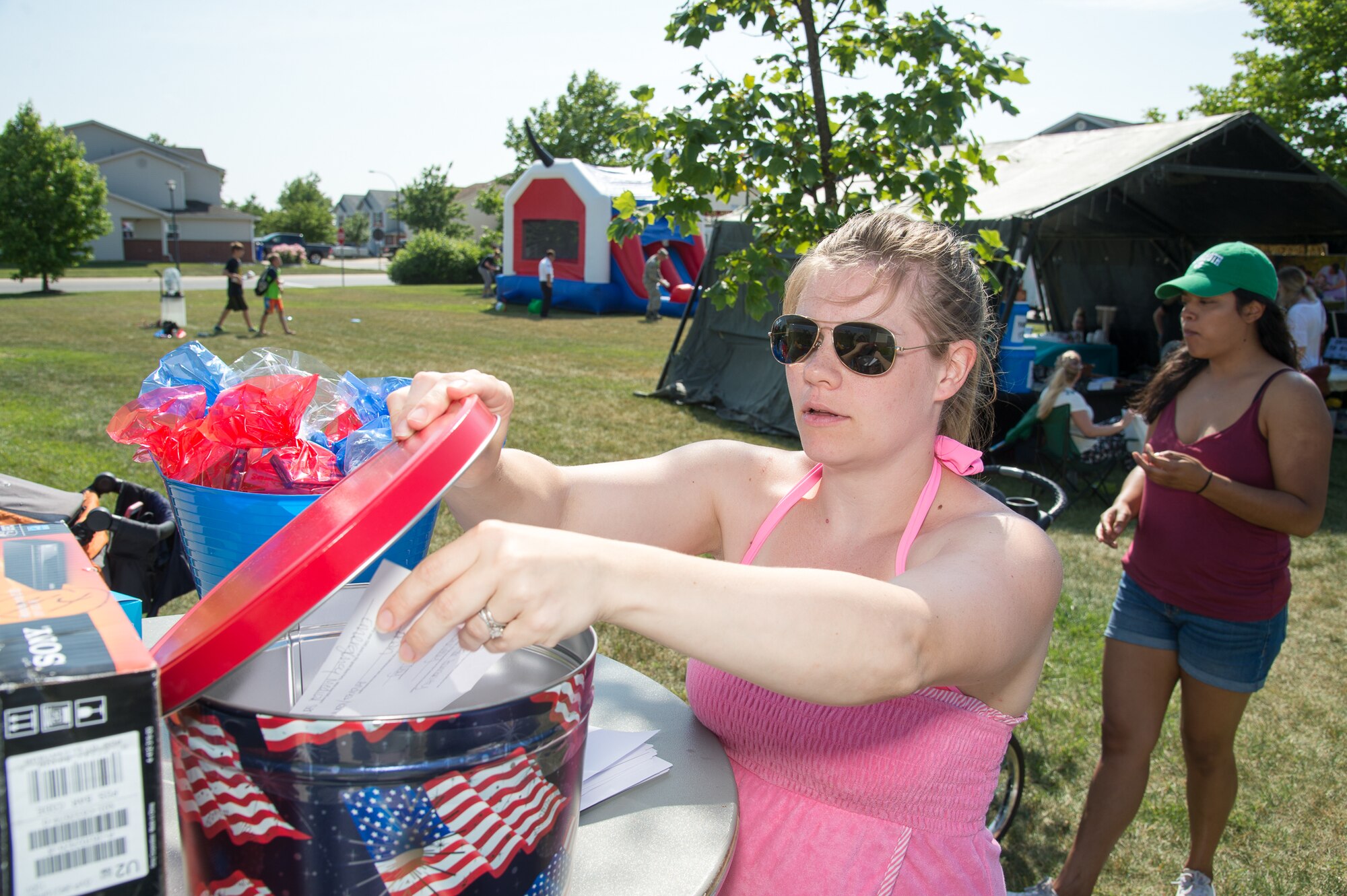 Kristin Strain, wife of Capt. Robert Strain, 9th Airlift Squadron, enters a free raffle drawing during the Hurricane Block Party June 15, 2017, in the Eagle Heights family housing on Dover Air Force Base, Del. The Eagle Heights housing office donated the raffle prizes and offered free food to the attendees. (U.S. Air Force photo by Mauricio Campino)
