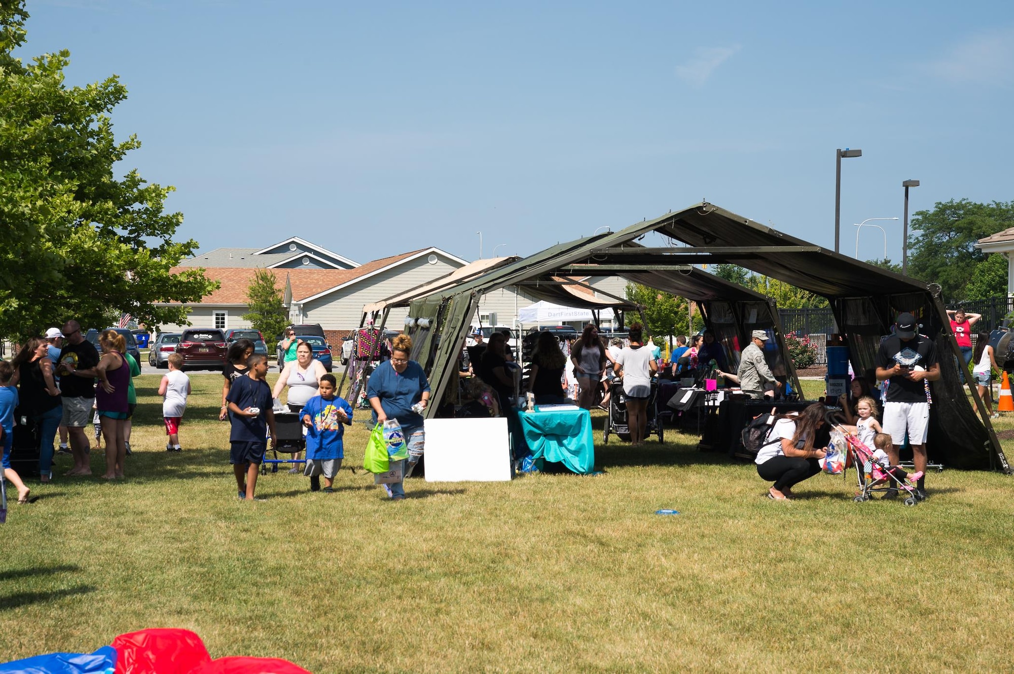 Attendees enjoy the Hurricane Block Party June 15, 2017, in Eagle Heights family housing on Dover Air Force Base, Del. The block party offered useful information for emergency preparedness, free food donated and prepared by the Eagle Heights housing staff, raffles, children’s activities and several booths set up by local vendors. (U.S. Air Force photo by Mauricio Campino)