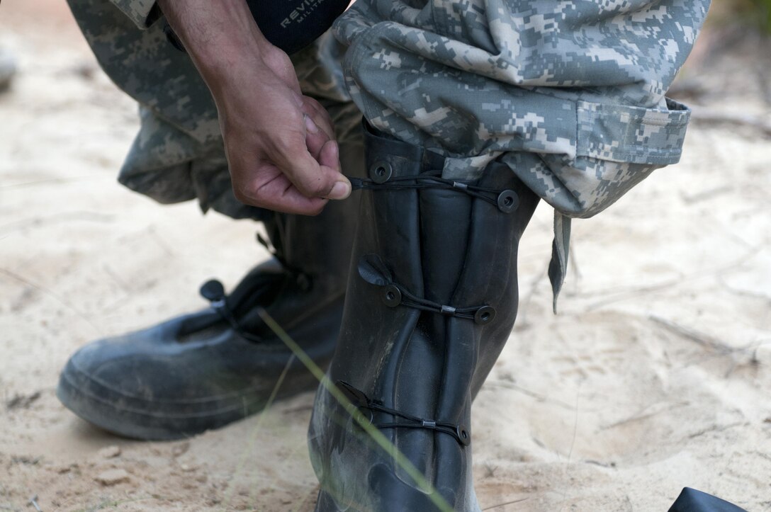 A Warrior laces his chemical gear during a nuclear, biological, chemical attack scenario during the combat skills testing event at the 2017 U.S. Army Reserve Best Warrior Competition at Fort Bragg, N.C. June 14. This year’s Best Warrior Competition will determine the top noncommissioned officer and junior enlisted Soldier who will represent the U.S. Army Reserve in the Department of the Army Best Warrior Competition later this year at Fort A.P. Hill, Va. (U.S. Army Reserve photo by Sgt. Jennifer Shick) (Released)