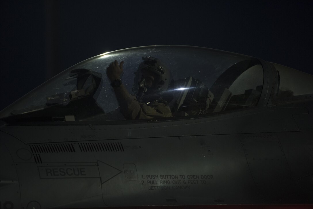 A 555th Expeditionary Fighter Squadron pilot waits for directions at Bagram Airfield, Afghanistan, June 16, 2017. The 555th EFS deployed to Bagram Airfield as part of a rotation of fighters, which have had a constant presence in Afghanistan for more than a decade. The F-16s presence here serves the counterterrorism mission and deters actions against coalition forces—day or night. (U.S. Air Force photo by Staff Sgt. Benjamin Gonsier) 