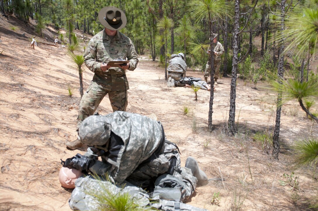 Warriors conduct a patient assessment during a nuclear, biological, chemical attack scenario during the combat skills testing event at the 2017 U.S. Army Reserve Best Warrior Competition at Fort Bragg, N.C. June 14. This year’s Best Warrior Competition will determine the top noncommissioned officer and junior enlisted Soldier who will represent the U.S. Army Reserve in the Department of the Army Best Warrior Competition later this year at Fort A.P. Hill, Va. (U.S. Army Reserve photo by Sgt. Jennifer Shick) (Released)