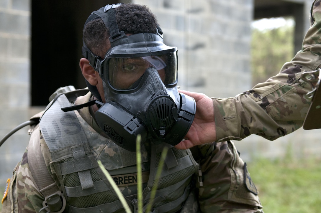 Pfc. Andrew Green, a paralegal specialist representing the (COMMAND), gets his mask checked by range cadre during the combat skills testing event at the 2017 U.S. Army Reserve Best Warrior Competition at Fort Bragg, N.C. June 14. This year’s Best Warrior Competition will determine the top noncommissioned officer and junior enlisted Soldier who will represent the U.S. Army Reserve in the Department of the Army Best Warrior Competition later this year at Fort A.P. Hill, Va. (U.S. Army Reserve photo by Sgt. Jennifer Shick) (Released)