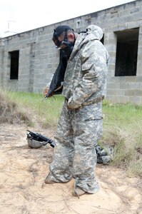 A Warrior dons his gear during a nuclear, biological, chemical attack scenario during the combat skills testing event at the 2017 U.S. Army Reserve Best Warrior Competition at Fort Bragg, N.C. June 14. This year’s Best Warrior Competition will determine the top noncommissioned officer and junior enlisted Soldier who will represent the U.S. Army Reserve in the Department of the Army Best Warrior Competition later this year at Fort A.P. Hill, Va. (U.S. Army Reserve photo by Sgt. Jennifer Shick) (Released)