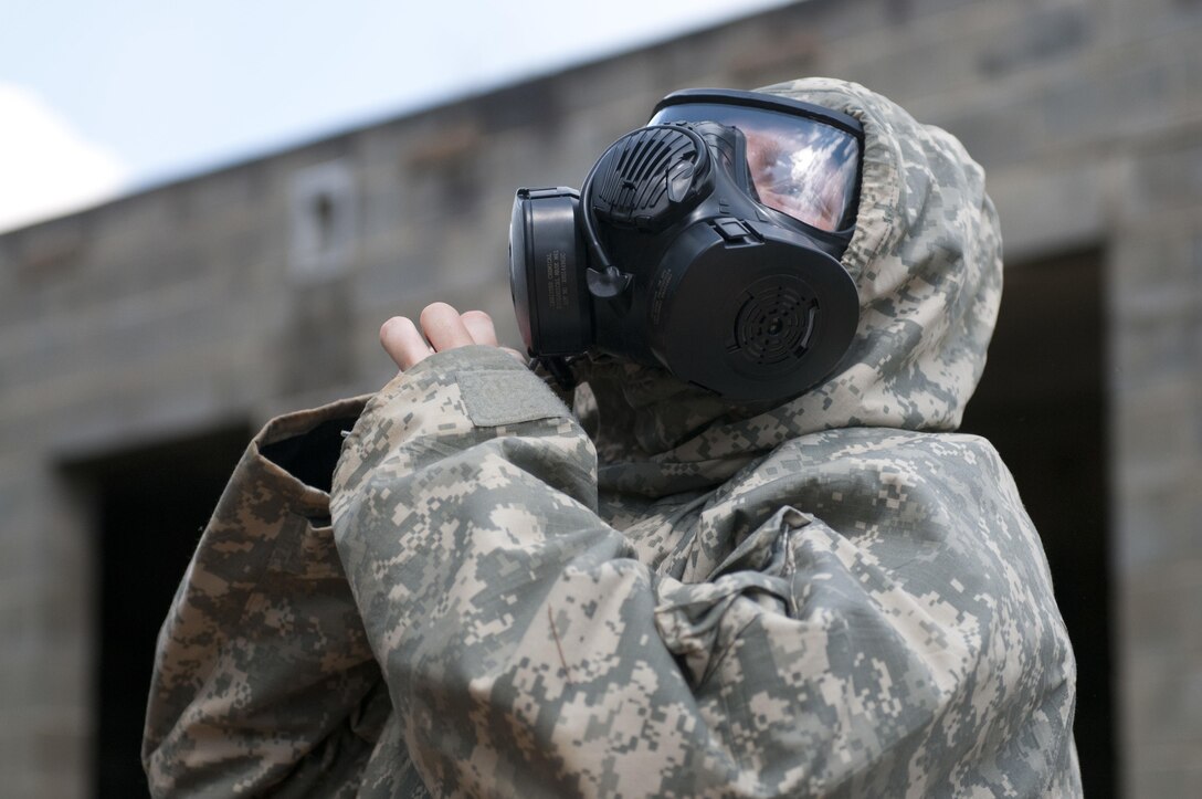 A Warrior dons her gear during a nuclear, biological, chemical attack scenario during the combat skills testing event at the 2017 U.S. Army Reserve Best Warrior Competition at Fort Bragg, N.C. June 14, 2017. This year’s Best Warrior Competition will determine the top noncommissioned officer and junior enlisted Soldier who will represent the U.S. Army Reserve in the Department of the Army Best Warrior Competition later this year at Fort A.P. Hill, Va. (U.S. Army Reserve photo by Sgt. Jennifer Shick) (Released)